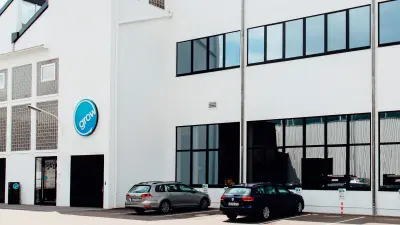 Outside view of a refurbished factory building the logo of the grow platform above the entrance