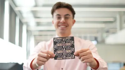 A person holds a PCB towards the camera. With copperdot's PCB service, you stay competitive by only paying the unit price of the PCBs you need. Bosch quality with no hidden costs.