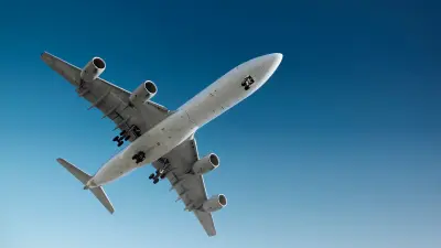Image of commercial airplane in the sky, as seen from down below