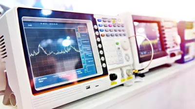 A person next to a control cabinet looks at their laptop. PCBs from copperdot are widely used in measurement and testing technology. PCBs from copperdot – trust in Bosch.